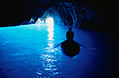 Person in a rowing boat in the Blue Grotto, Capri, Campania, Italy, Europe