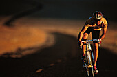Man riding a racing bike through Death Valley, Bike tour, Death Valley, California, USA