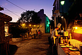 Cook at open air restaurant, Frigliana, Village, Province of Málaga, Andalusia, Spain