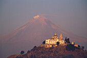 Church of Cholula and Popocatepetl volcano in the evening sun, Mexico, America