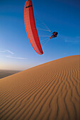 Paraglider above a dune, Namibia, Africa