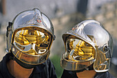 Two firemen wearing futuristic helmets, Paris, France