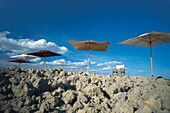 Angular sunshades and chair in front of blue sky, Tuscany, Italy