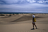 Woman walking on the sanddunes at Playa del Ingles, Gran Canaria, Canary Islands, Spain