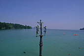 Pole with ctholic figures, Mainau Island, Lake Constance, Baden-Wuerttemberg, Germany
