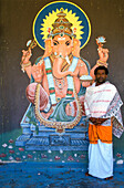 Malaysian man standing in front of painting, Malaysia, Asia