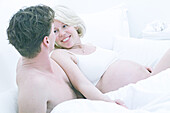 Couple in bed, people pregnant