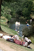 People relaxing, relaxing at river Christchurch, New Zealand