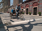 Man riding bike, Shanghai, China