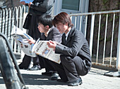 Men reading newspapers, Shanghai, China