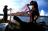 Fishermen cleaning fishing nets, Mount Batur, Bali, Indonesia