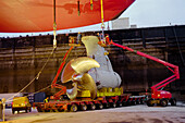 Low loading truck bringing mermaid motor pod, attaching the mermaid motors, dry dock, Queen Mary 2, Saint-Nazaire, France
