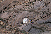 Eine Gruppe Wanderer läuft auf einem Pfad über Felsen, Vega de Rio Palma, Fuerteventura, Kanarische Inseln, Spanien, Europa, Europa