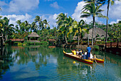 People in a traditional boat in front of Polynesian Cultural Center, Laie, Oahu, Hawaii, USA, America