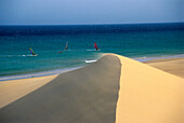 Sand dune in front of sailboarders in the sea, Playa de Sotavento de Jandia, Fuerteventura, Canary Islands, Spain, Europe