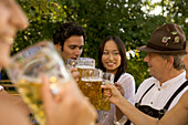 Friends toasting in beergarden, Bavaria, Germany