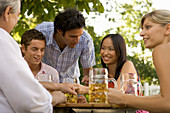 Friends in a beer garden, Fingerhakeln, Lake Starnberg, Bavaria, Germany