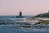 Boat off the coast in the evening light, Walvis Bay, Namibia, Africa