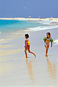Two girls playing on the beach, Santa Maria, Sal, Cape Verde, Africa