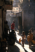 People in an narrow alley at the Old Town, Zanzibar, Tanzania, Africa