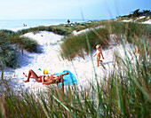 Mother with daughter lying on dunes, Dueodde, Bornholm, Baltic Sea, Denmark