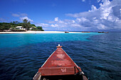 Wooden boat off the beach of Prison Island under blue sky, Zanzibar, Tanzania, Africa