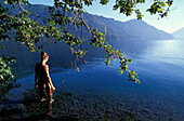 Woman standing in Lake Crescent, Olympic National Park, Washington, USA