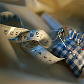 Sewing-needle and cushion, tape measure Stillife