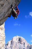 Male rock climber at Cinque Torre, Cortina d'Ampezzo, Dolomites, South Tyrol, Italy