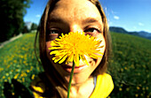 Close up of a woman holding a flower, Salzkammergut, Austria