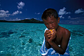 Boy eating Mango, Bora Bora French Polynesia
