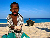 Boy playing with Sand, Carribbean Beach, Cartagena, Colombia, South America
