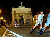 People inline skating in front of the Siegestor at night, Ludwigstrasse, Munich, Bavaria, Germany, Europe