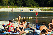 People sunbathing and bathing at Isar River, Munich, Bavaria, Germany
