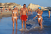 Young people on the beach, Praia da Rocha, Algarve, Portugal, Europe