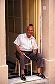 Man sitting at entrance, Valletta Malta
