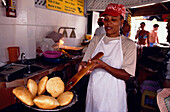 Woman baking Bake and Shark, Maracas Bay Trinidad, Carribbean