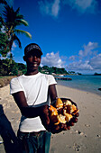 Man selling shells, Man offers shells at Cayo Levantado, Bahia de Samana, Dominican Republic