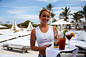 Waitress with cocktails at Nikki Beach Club, South Beach, Miami, Florida, USA, America