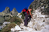 Woman climbing up, Lac de Capitello, Corsica, France