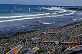 Windsurfer and windsurfs on the beach, Pozo Izquierdo, Gran Canaria, Canary Islands, Spain