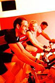 Spinning, Men and woman in gym on exercise bikes, Spinning, leos Sports Club Muenchen