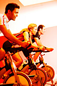 Spinning, Men and woman in gym on exercise bikes, Spinning, leos Sports Club Muenchen