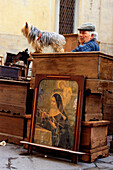 Salesperson with his pet at the Antiques market, Arezzo, Tuscany, Italy