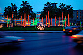 Illuminated palm trees at a roundabout in the evening, Dubai, UAE, United Arab Emirates, Middle East, Asia