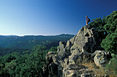 Hiker at Monte Sepada enjoying the views, Sardinia, Italy