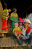 Portrait grandfather holding child, hill tribe, Myanmar