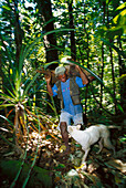 Hunter shoulder a wild-pig, New Britannia Papua New Guinea