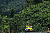 Funky yellow car on street, Coromandel Peninsula, North Island, New Zealand