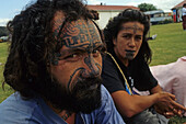 Maori couple, Waitangi Day, NZ, Portrait Maoris with moko tattoo, at Waitangi Day protest and celebration